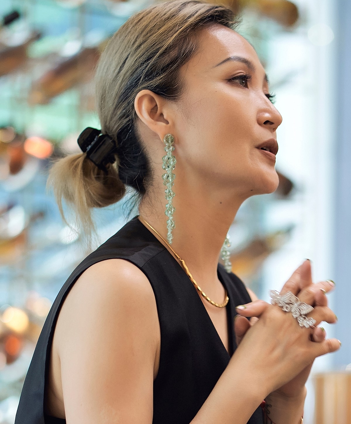 Woman with stylish jewelry and hairstyle.