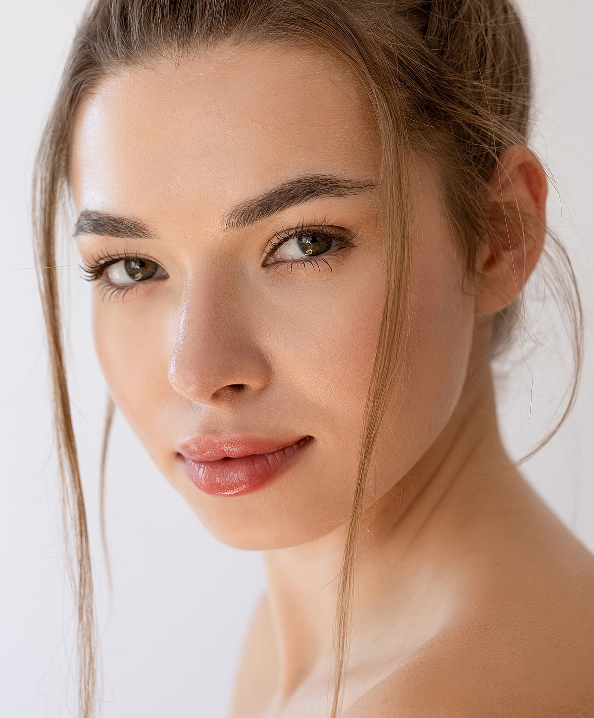 Close-up portrait of a young woman smiling.
