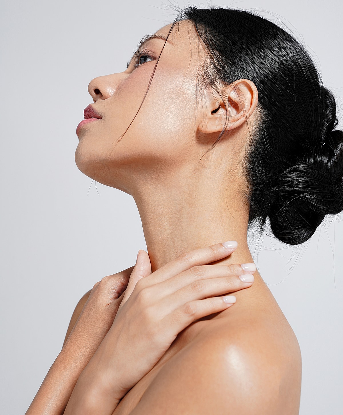 Woman with curly hair in soft lighting.