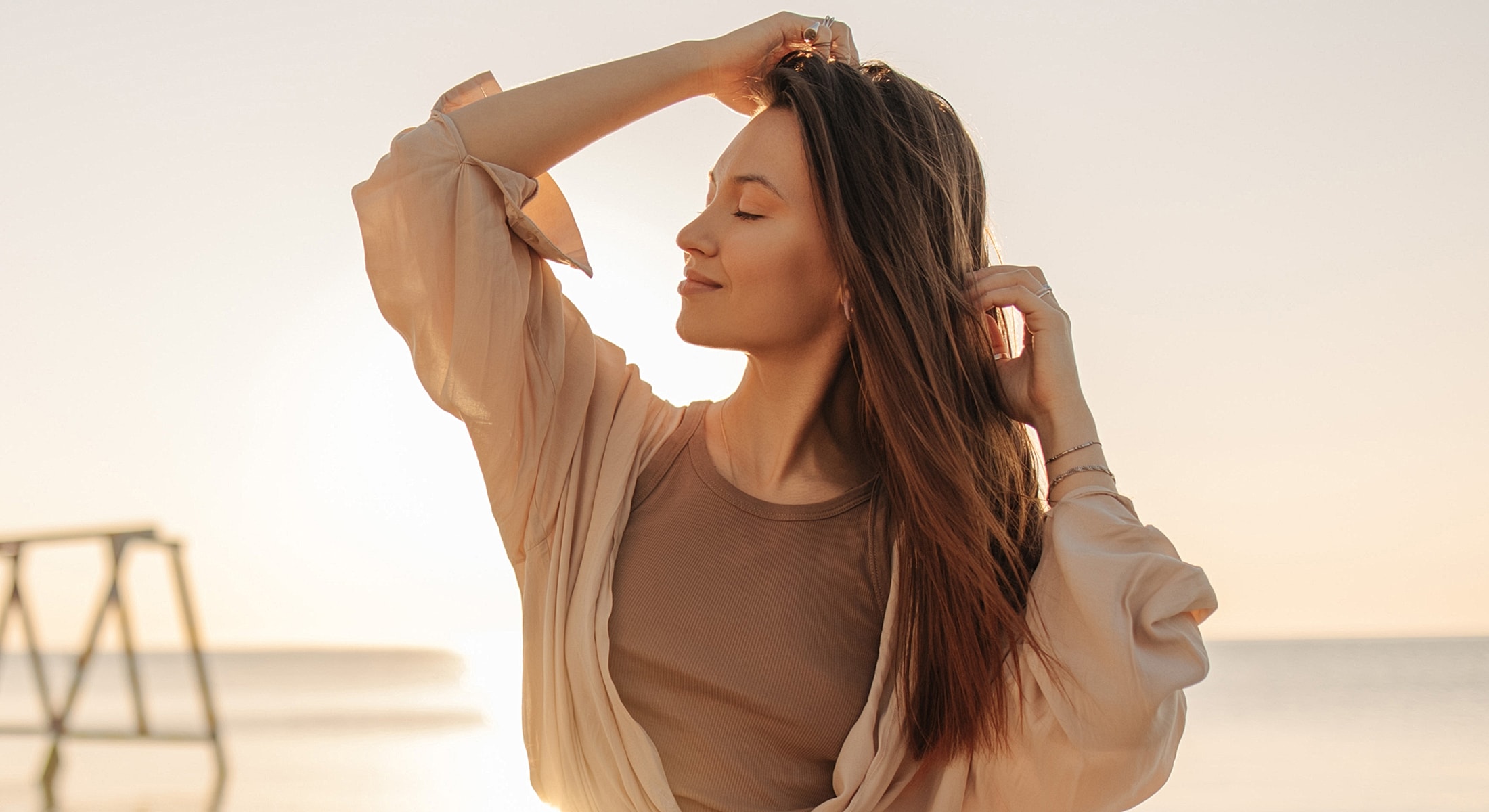 Woman enjoying sunset at the beach.
